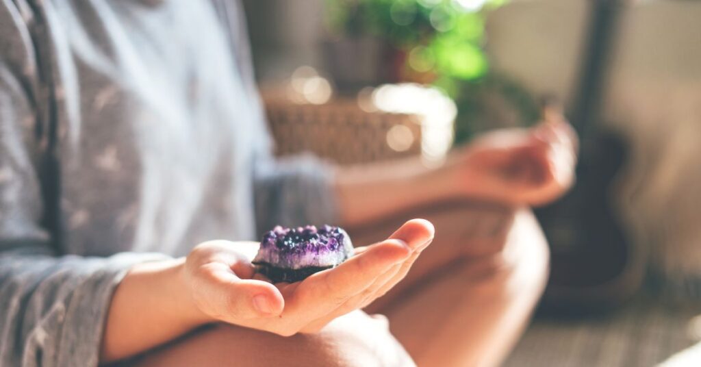 Hold grounding stones during meditation
